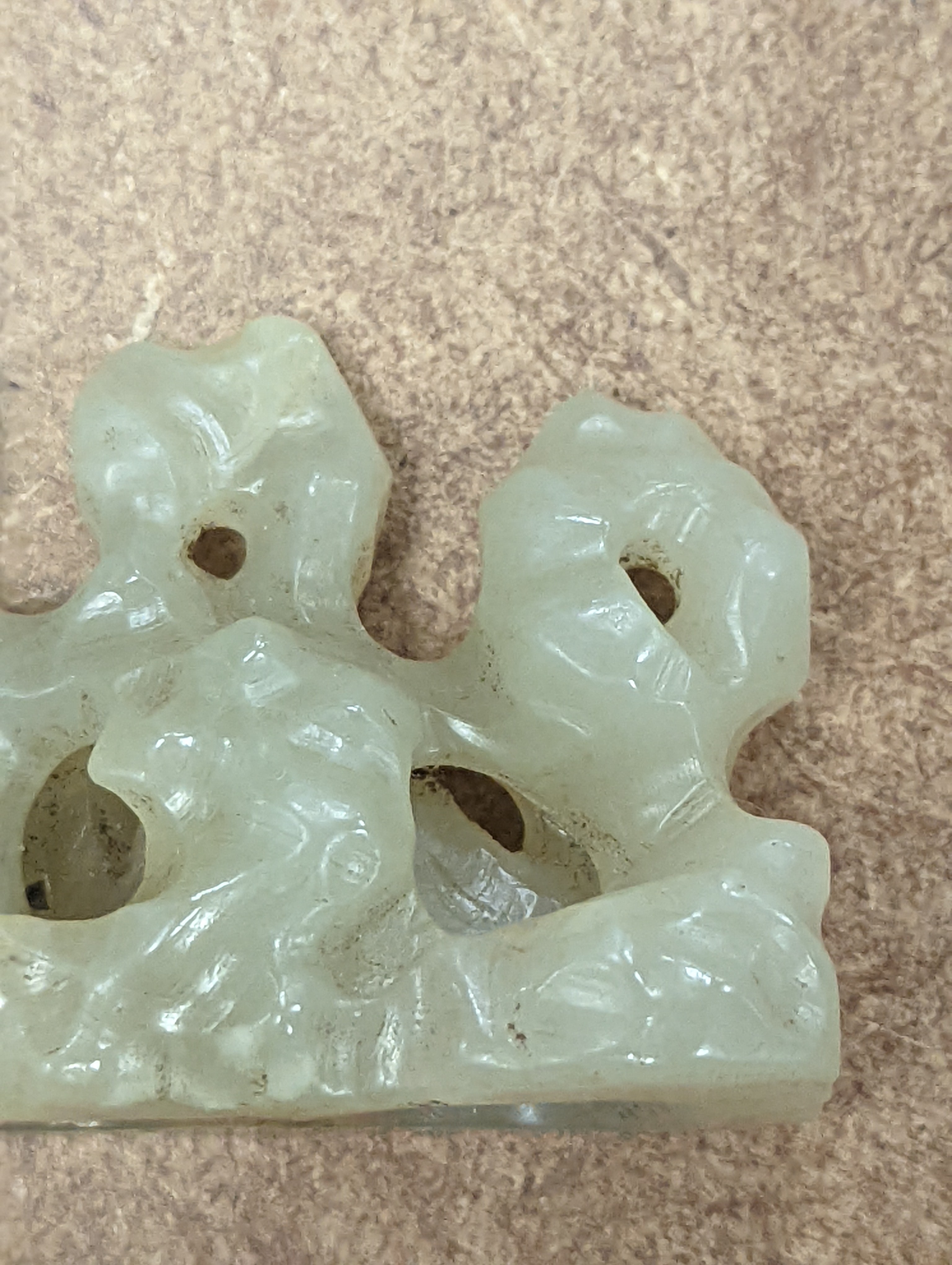 A Chinese celadon jade brush rest, 8cms wide